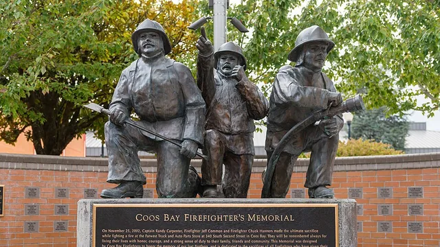 Bronze statues of three firefighters at the Coos Bay Firefighter's Memorial