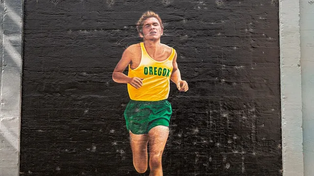 Mural of Steve Prefontaine running in a green and gold uniform